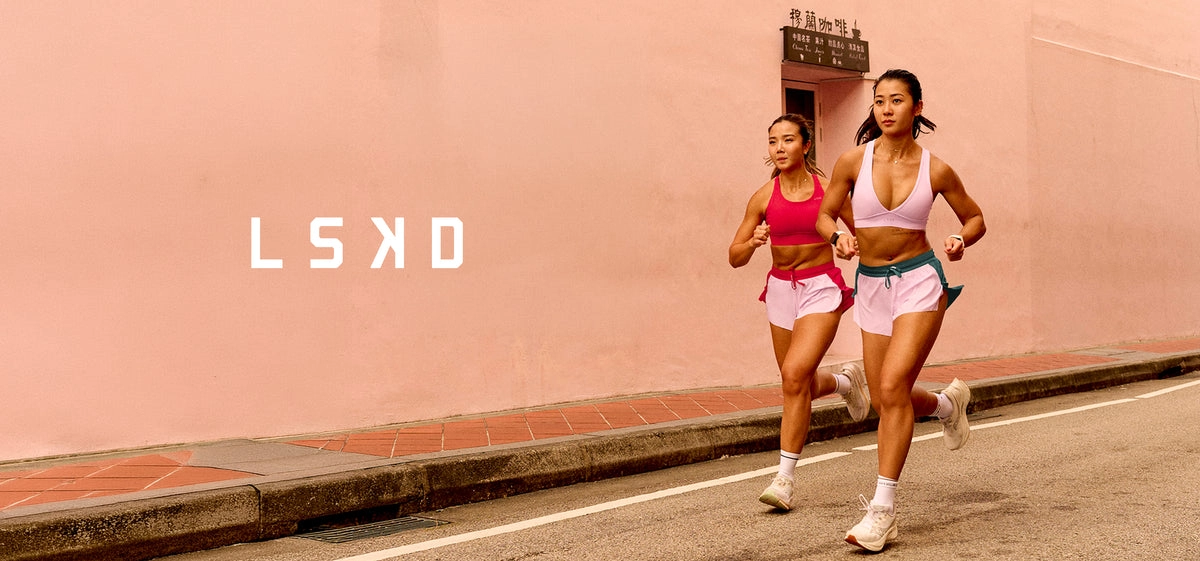 LSKD campaign photo: two runners passing a pink wall